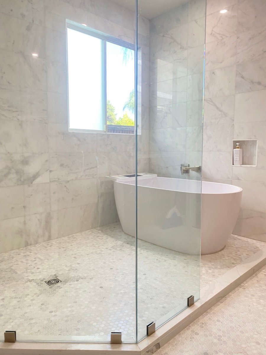 Bathroom with a freestanding tub and hexagon mosaic floor tile