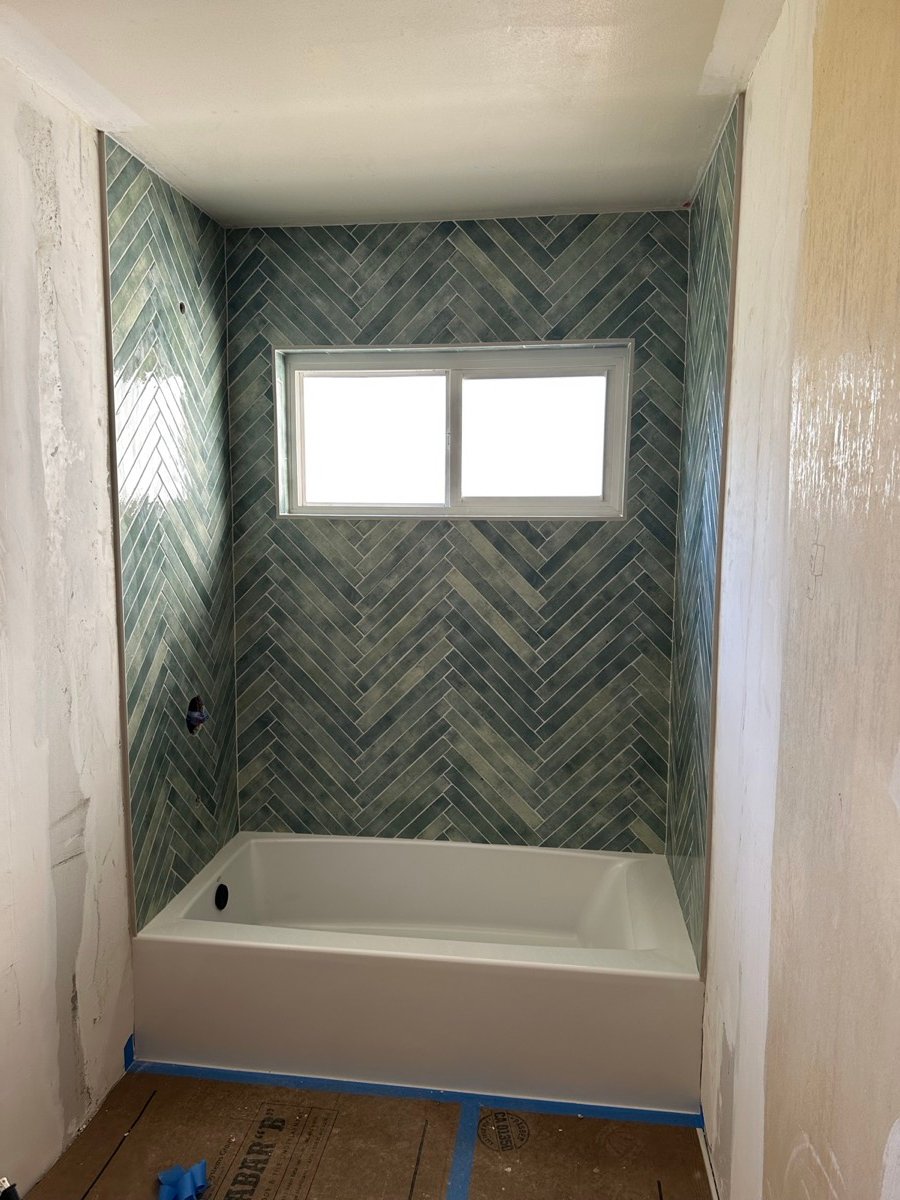 Bathtub installation with tiled surround walls