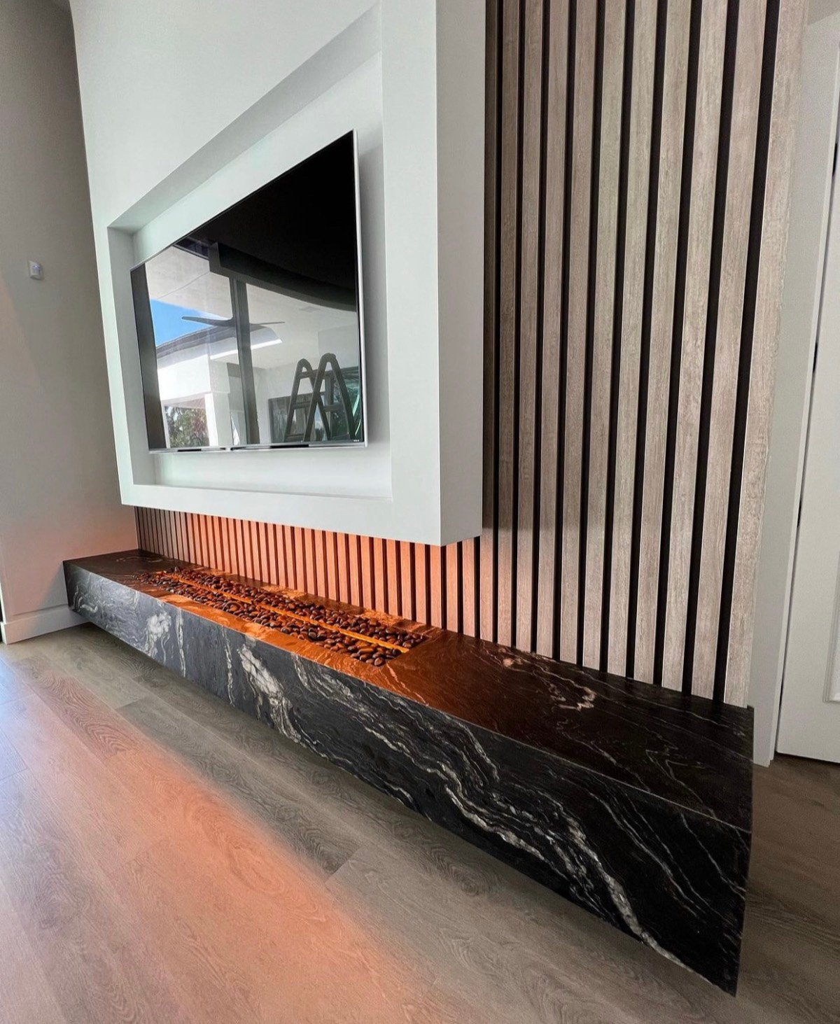 Bookmatched marble bench with a linear fire feature