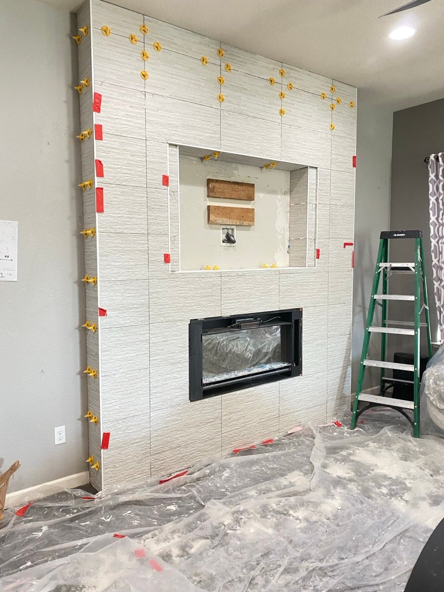Tile fireplace surround installation with leveling clips in place