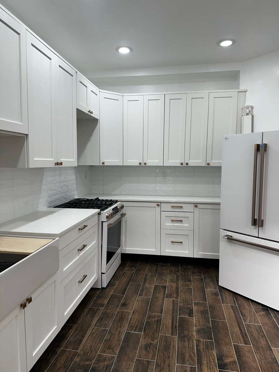 Kitchen with a tile backsplash and matching wood-look tile flooring