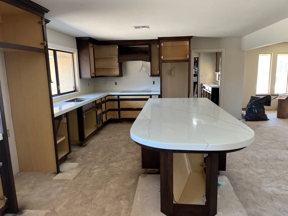 Kitchen island with a waterfall-edge quartz countertop
