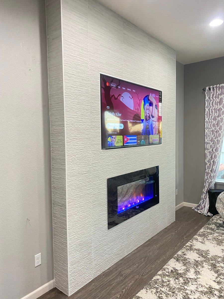 Textured tile media wall with a recessed fireplace and TV niche